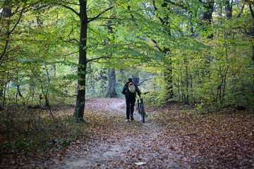 Male bicyclist in autumn park