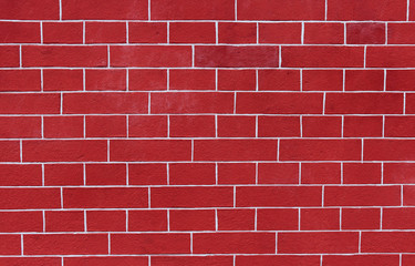 Close up photo of a red brick wall to use as a background pattern or texture.