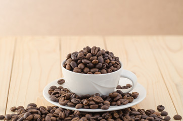 Cup of coffee full of coffee beans