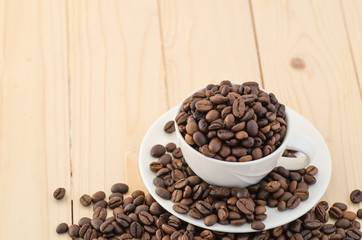 Cup of coffee full of coffee beans