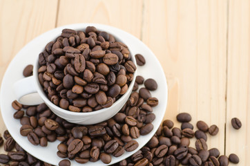Cup of coffee full of coffee beans