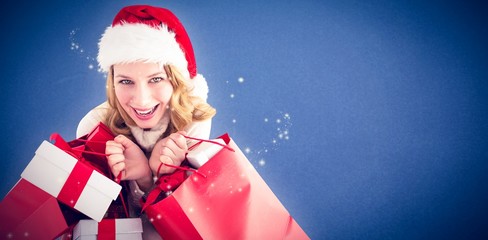 Festive woman holding presents and shopping bags