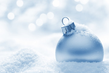 Grey christmas ball on snow 