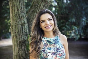 Portrait of a young girl smiling with nature background