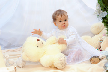 Baby playing in a park near the tents of baldachin © Andriy Petrenko