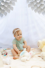 Baby playing in a park near the tents of baldachin © Andriy Petrenko