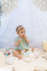 Baby playing in a park near the tents of baldachin © Andriy Petrenko