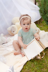 Baby playing in a park near the tents of baldachin © Andriy Petrenko