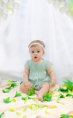 Baby playing in a park near the tents of baldachin © Andriy Petrenko