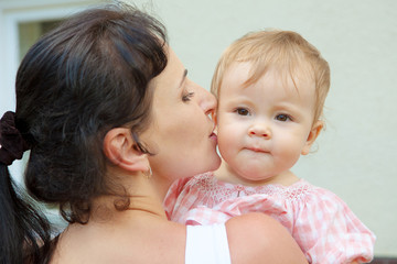 girl embracing the mother in park