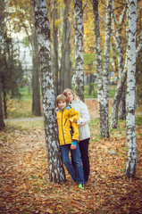 Mother and little son in park or forest, outdoors.