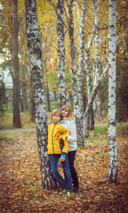 Mother and little son in park or forest, outdoors.