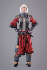 Woman warrior in battle armor. Isolated on the gray background