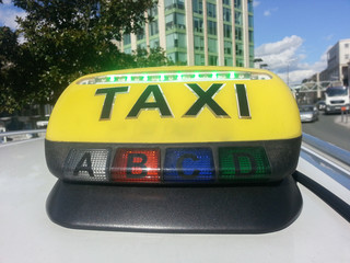 Taxi sign in a city in a day