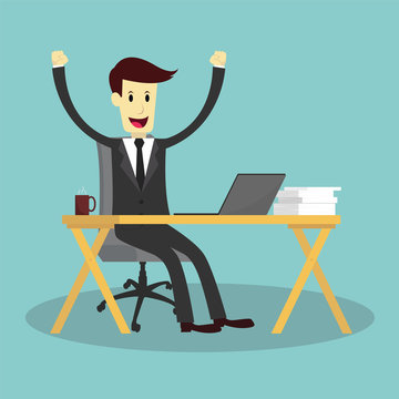 Successful businessman on working desk and feeling happy