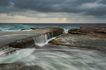Cloudy seascape with flowing water