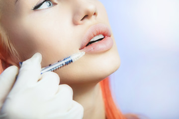 Woman Geting an Injection in her Lips in Beauty Salon