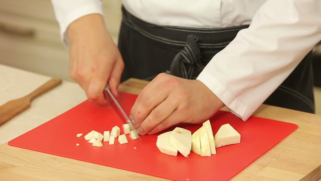 Chopping celery root into cubes