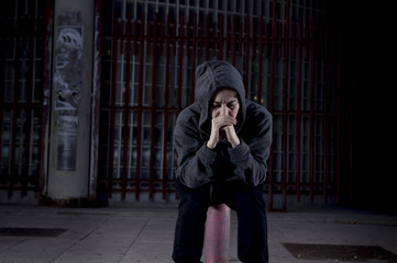Naklejka premium sad woman alone on street suffering depression desperate and helpless wearing hoodie