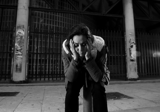 woman alone on street suffering depression looking sad desperate