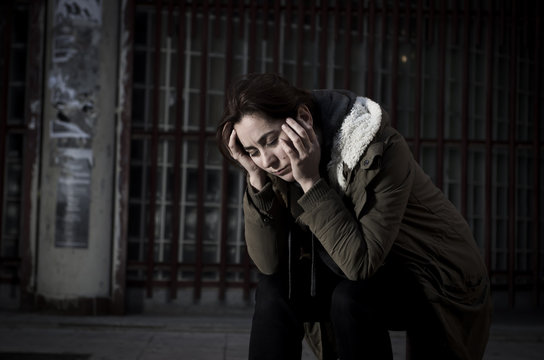 woman alone on street suffering depression looking sad desperate and helpless