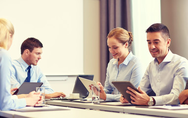 smiling business people with tablet pc in office