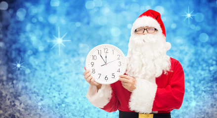 man in costume of santa claus with clock