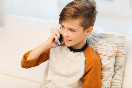 happy boy calling on smartphone at home