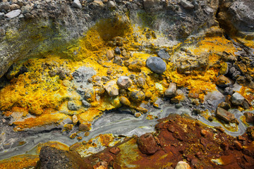 Colorful ground with creek in the volcanic desert of Whakarri or White Island in the Bay of Plenty, New Zealand.