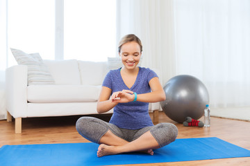 happy woman with heart-rate watch exercising