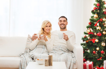 happy couple at home with christmas tree
