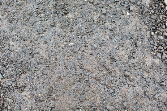 close up of wet gray gravel road or ground