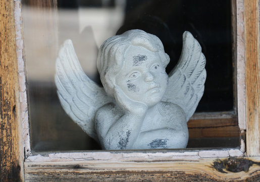 Angel statue in the old window