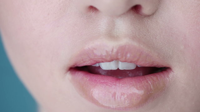 woman close up lips on blue background