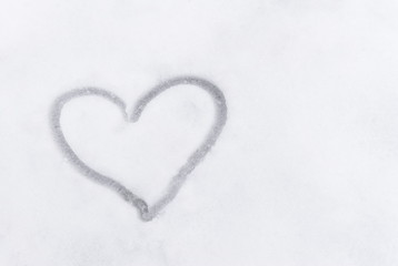 Love heart sign writen on the snow
