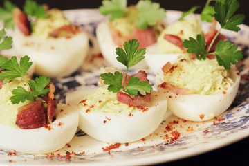 deviled eggs appetizer with avocado and bacon