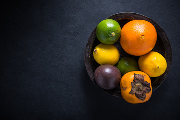 fresh tropical and exotic fruits in rustic bowl