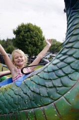 Young girl on green fair ride