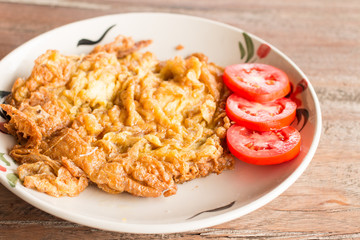 Fries egg (omlet) on plate in Thai style