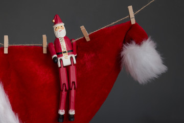 Red Christmas hat and Santa Claus doll hang on rope, Merry Christmas