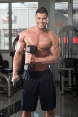 Male Bodybuilder Doing Heavy Weight Exercise For Biceps