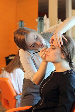  Professional Make-up artist doing glamour model makeup at work 