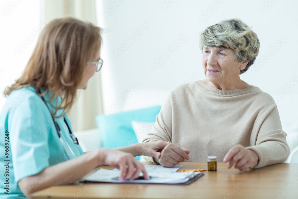 Wall mural Senior woman at doctor's office