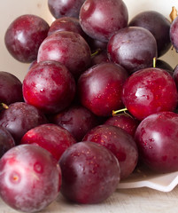 Ripe plums and cherry-plum on a table