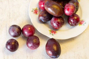 Ripe plums and cherry-plum on a table