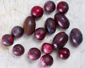 Ripe plums and cherry-plum on a table