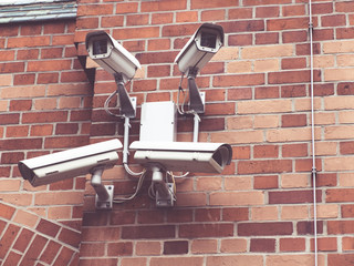 security cameras on brick wall