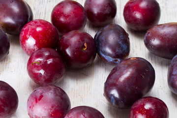 Ripe plums and cherry-plum on a table