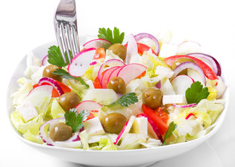 The Greek and Italian food - fresh vegetable salad on the table.