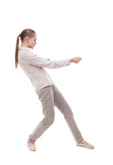 back view of standing girl pulling a rope from the top or cling